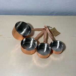 Rose gold colored metal measuring cups